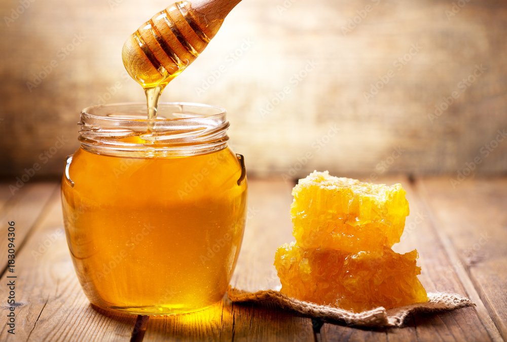 pouring honey into jar of honey pouring honey into jar of honey