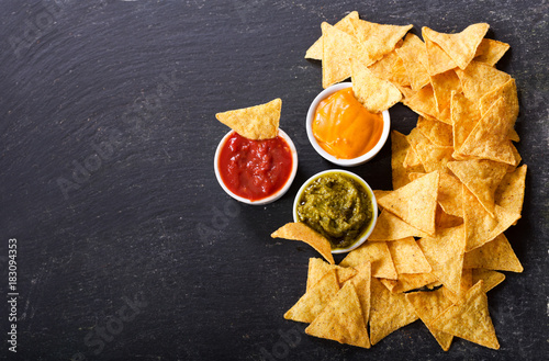 mexican nachos corn chips with guacamole, salsa and cheese dip