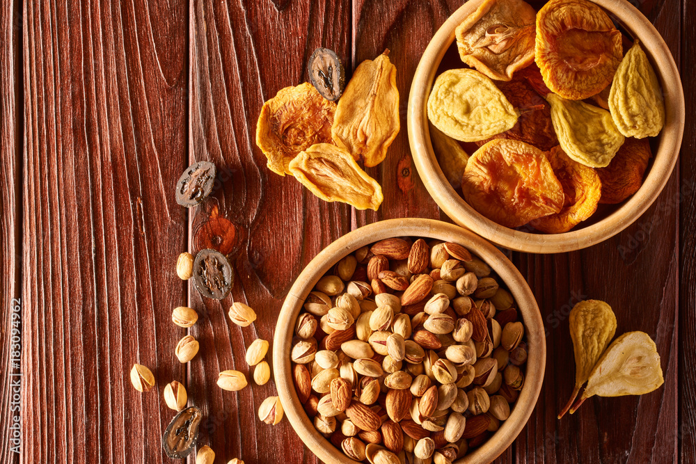 Dried fruits and nuts on wooden background Dried fruits and nuts on wooden background