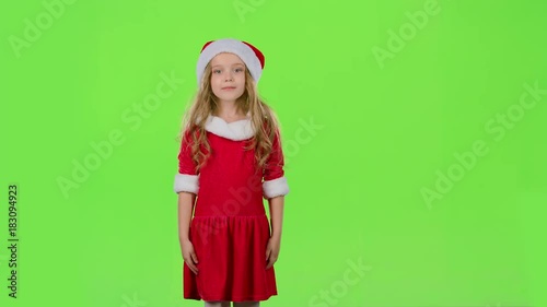 Child in red New Year costumes are dancing. Green screen. Slow motion photo