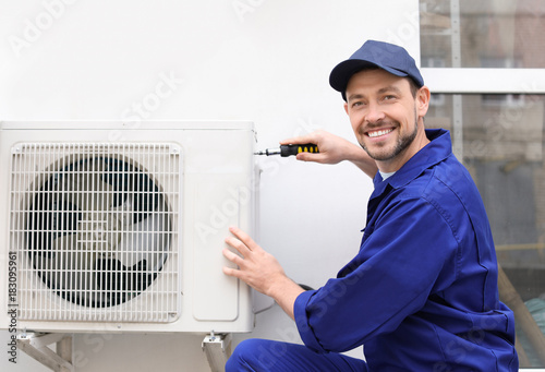 Male technician repairing a...