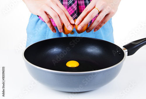 Cracking an egg into a frying pan