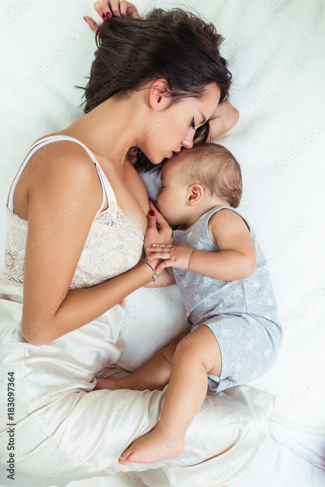 Beautiful mother breast feeding her cute little baby. Beautiful mother breast feeding her cute little baby.