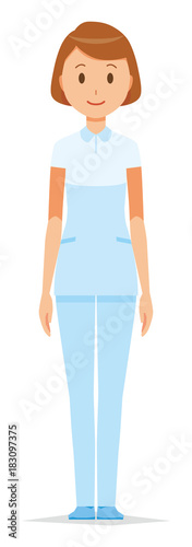 A female nurse wearing a white uniform is standing