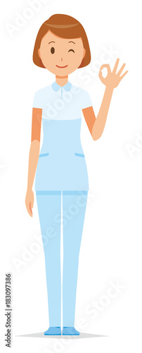 A female nurse wearing a white uniform is doing an okay sign
