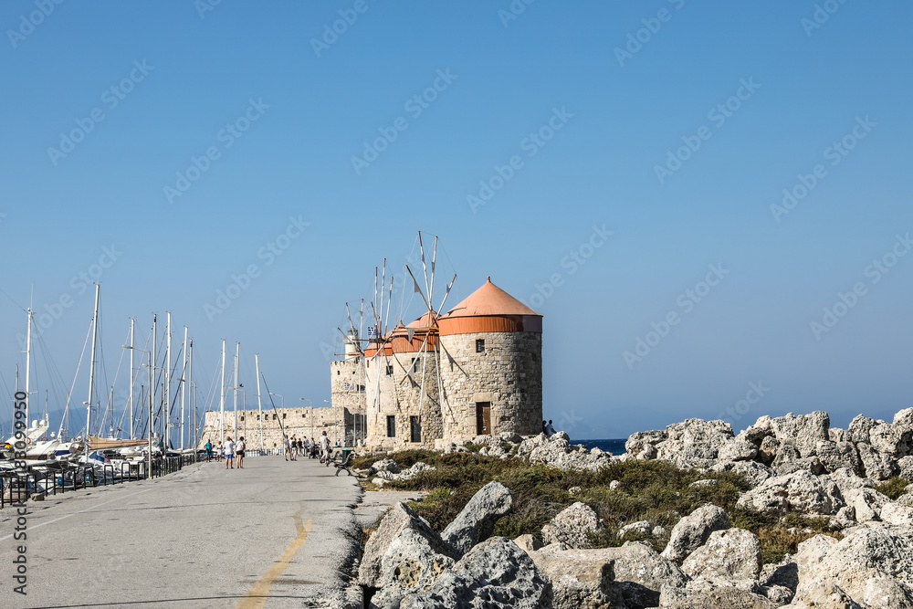 Mandhraki Harbor, the yacht and ferry harbour with windmills in the city of Rhodes in Greece
