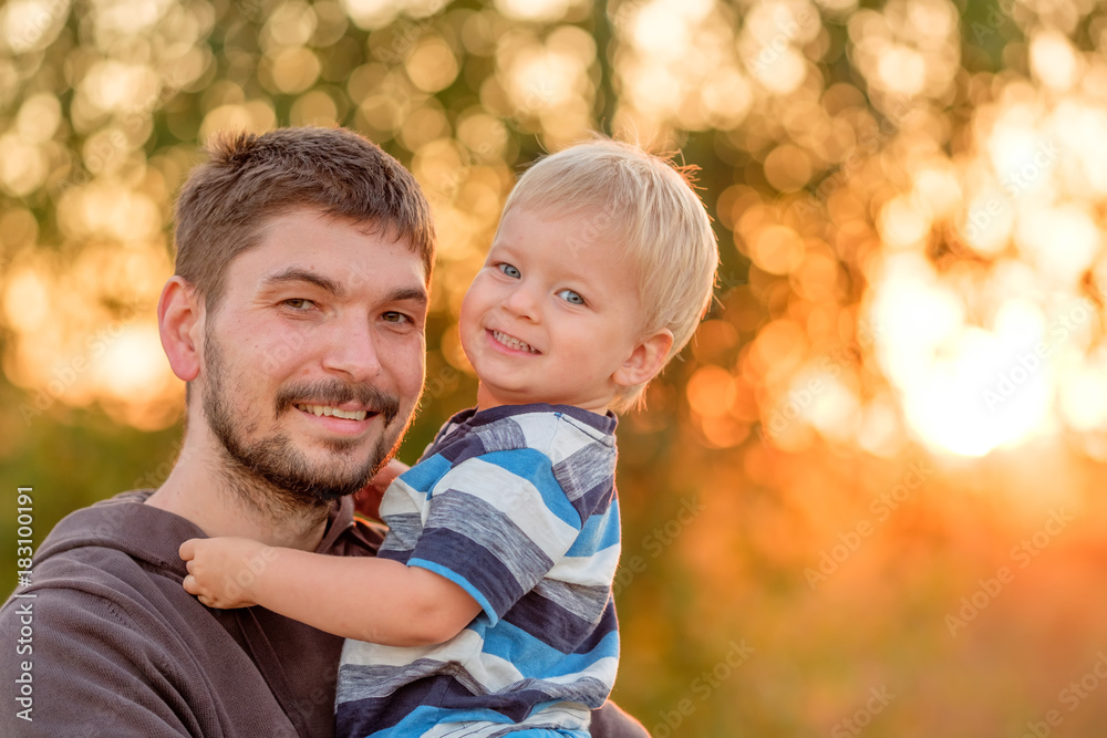 Father and son outdoor portrait in sunset sunlight Father and son outdoor portrait in sunset sunlight