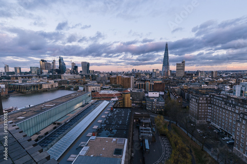 Photography Elevated aerial view of modern London cityscape skyline rooftops at sunset with