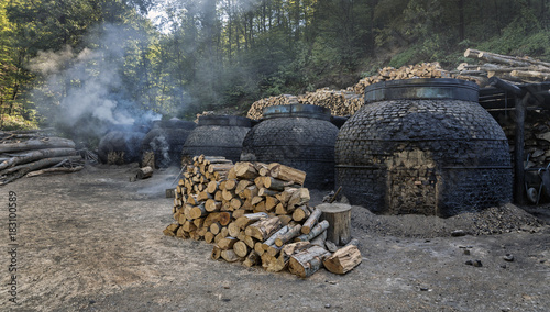 Fototapeta Naklejka Na Ścianę i Meble -  The production of charcoal in a traditional manner in the forest