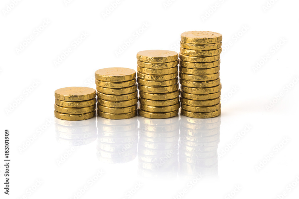 Golden coin stacks on a white Golden coin stacks on a white