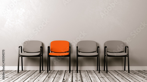 One Different Colored Chair in a Row of Grey