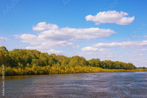 Calm landscape with river, blue sky and white clouds. Bank of Oka River (Volga tributary) in Ryazan region. Russia