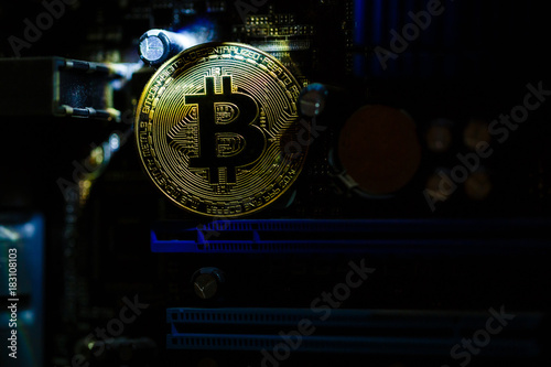 Gold coin of crypto currency bitcoin on computer network chip toned