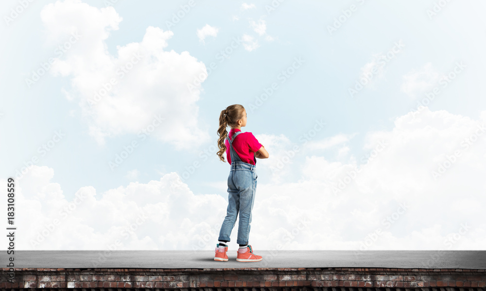 Concept of careless happy childhood with girl looking far away Concept of careless happy childhood with girl looking far away