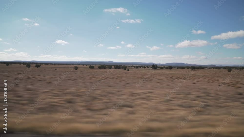 Driving plate side view moving through hills and fields Driving plate side view moving through hills and fields