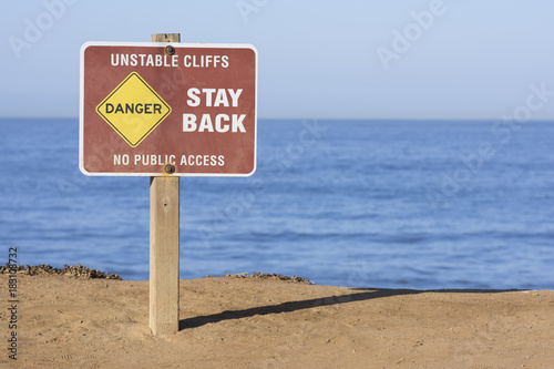 Billede på lærred Danger - unstable cliffs sign on seaside bluffs
