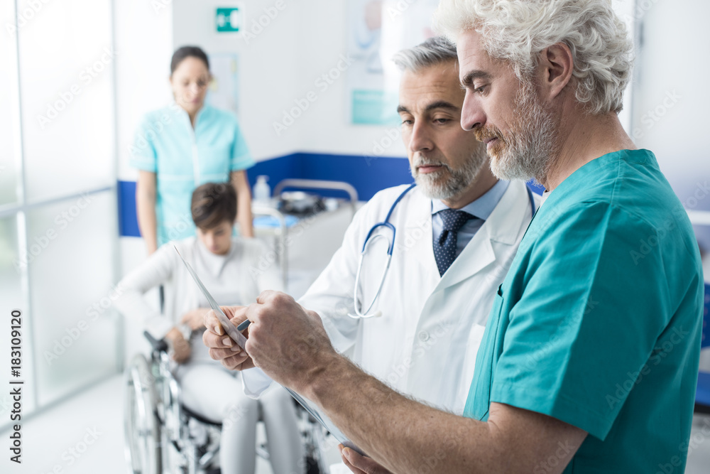 Fototapeta premium Professional doctors examining patient's x-ray