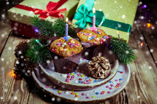 Vanilla cupcake with candle on wooden background. Birthday / Christmas greeting card © yusev