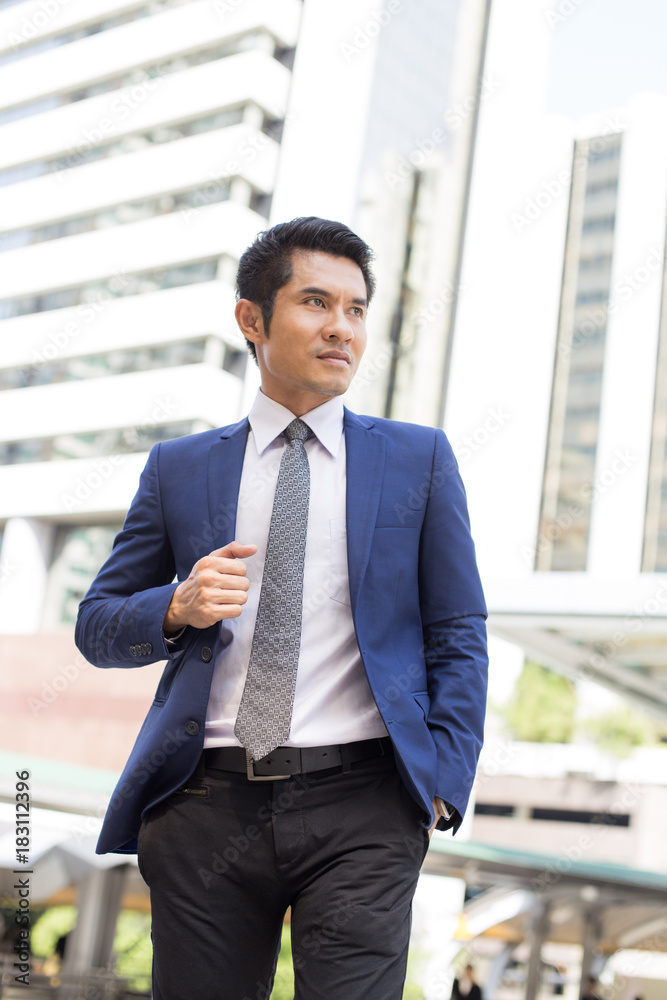 Young Hnadsome Businessman standing in City looking and ready for Work. Young Businessman have Confident for Work with Leader concept. Asian Businessman Thinking for Work in City. Young Hnadsome Businessman standing in City looking and ready for Work. Young Businessman have Confident for Work with Leader concept. Asian Businessman Thinking for Work in City.