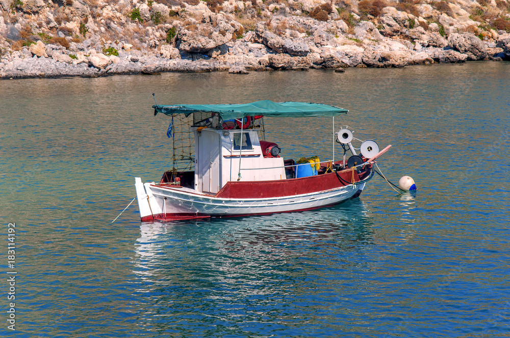 White and red docked vintage wooden motor boat at sea