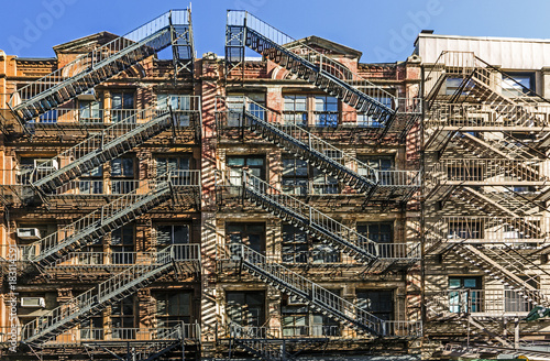 facade of old brick houses i NEw York with iron fire laders photo