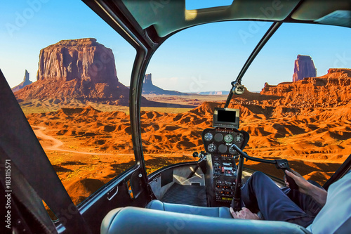 Helicopter cockpit with pilot arm and control console inside the cabin on scenic flight of Monument Valley Navajo Tribal Park, Arizona and Utah, America.