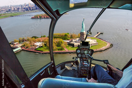 Helicopter flight view of Liberty Island and the famous Statue of Liberty monument symbol of New York City, United States.