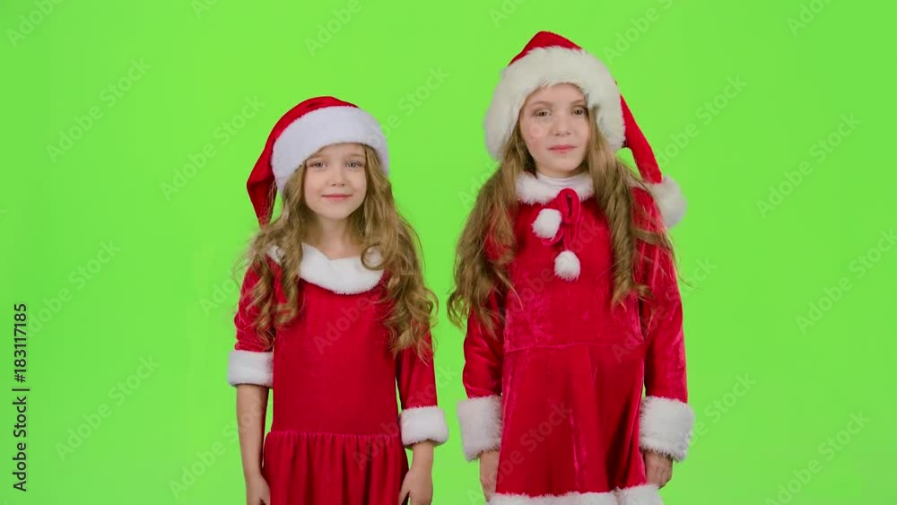 Children in a red suit are standing in the room and wink. Green screen Children in a red suit are standing in the room and wink. Green screen