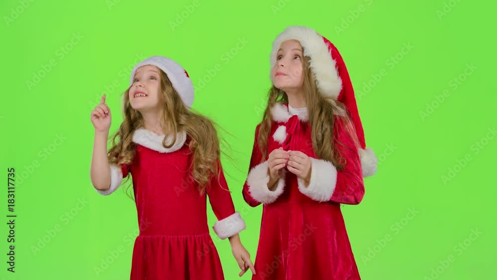 Children girls in the Christmas costumes inflate the stellar pollen. Green screen Children girls in the Christmas costumes inflate the stellar pollen. Green screen