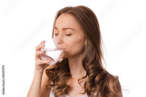 Beautiful young woman holding glass of water health