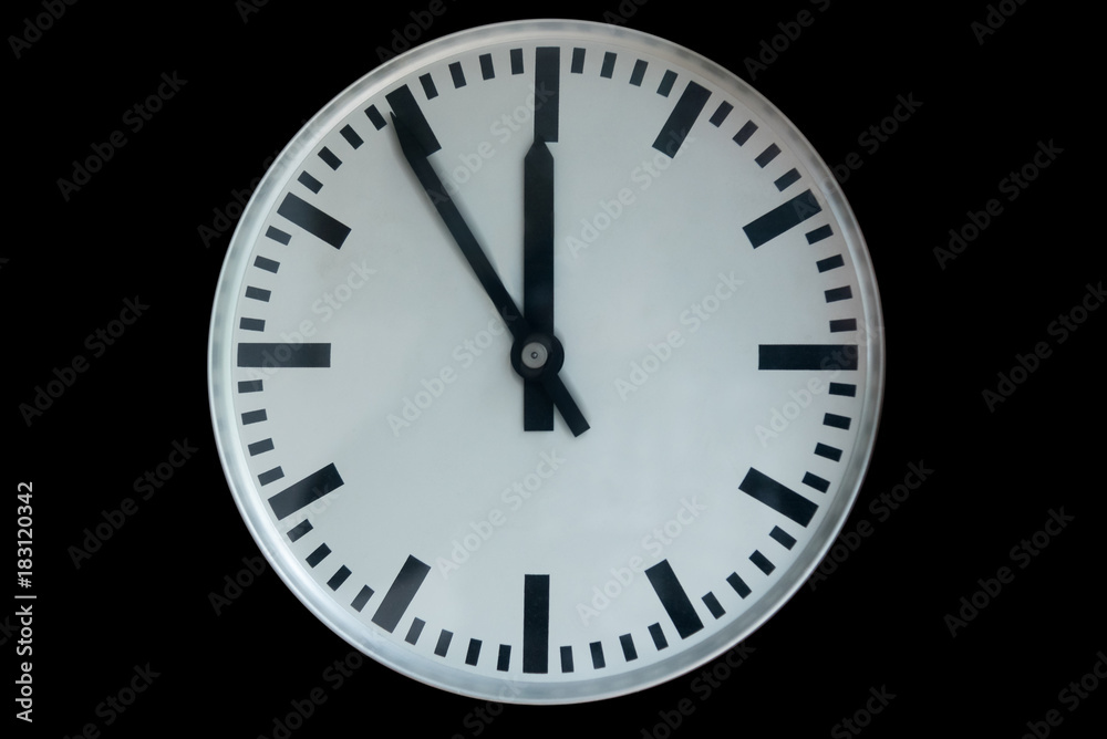 old analog clock showing five to twelve isolated on black background old analog clock showing five to twelve isolated on black background