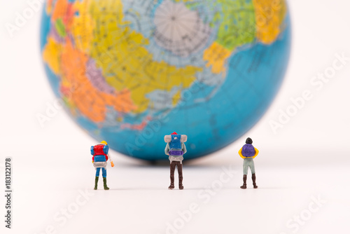 Miniature figure person backpack team, travelers standing with world map,tourism concept