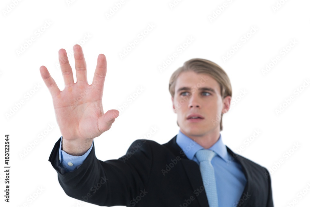 Businessman gesturing on invisible interface Businessman gesturing on invisible interface