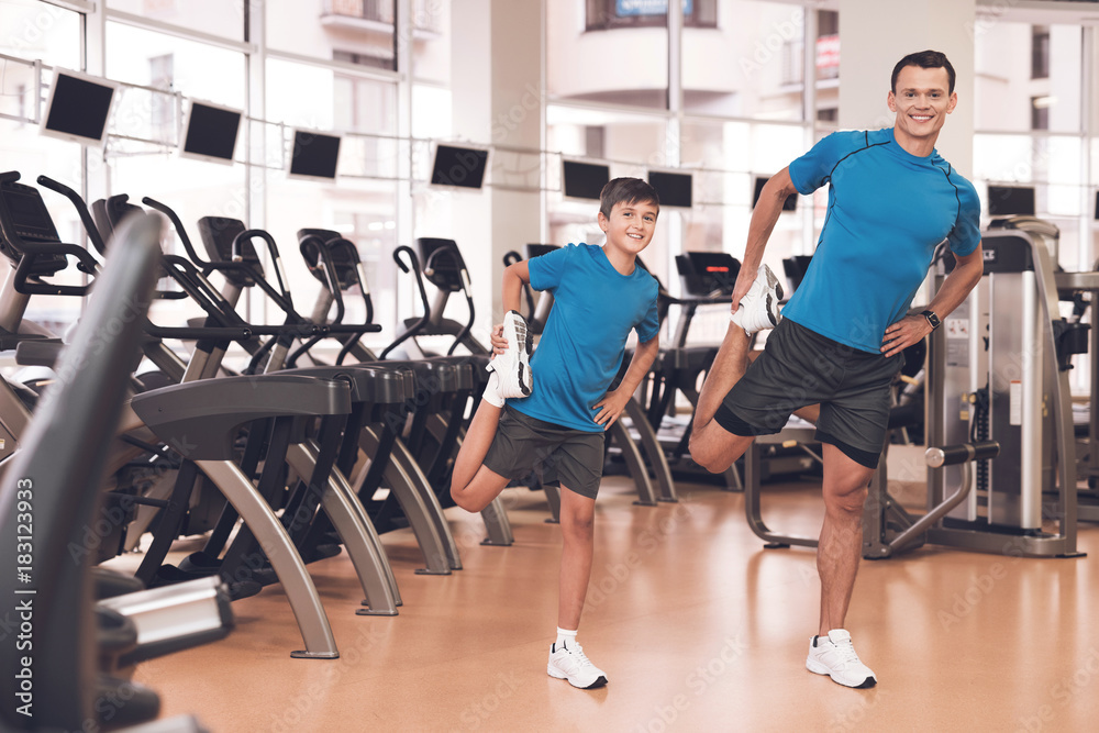 Dad and son in the same clothes in gym. Father and son lead a healthy lifestyle.