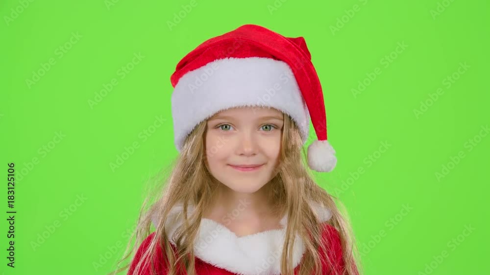 Baby in a beautiful suit and a red New Year's cap smiles. Green screen Baby in a beautiful suit and a red New Year's cap smiles. Green screen