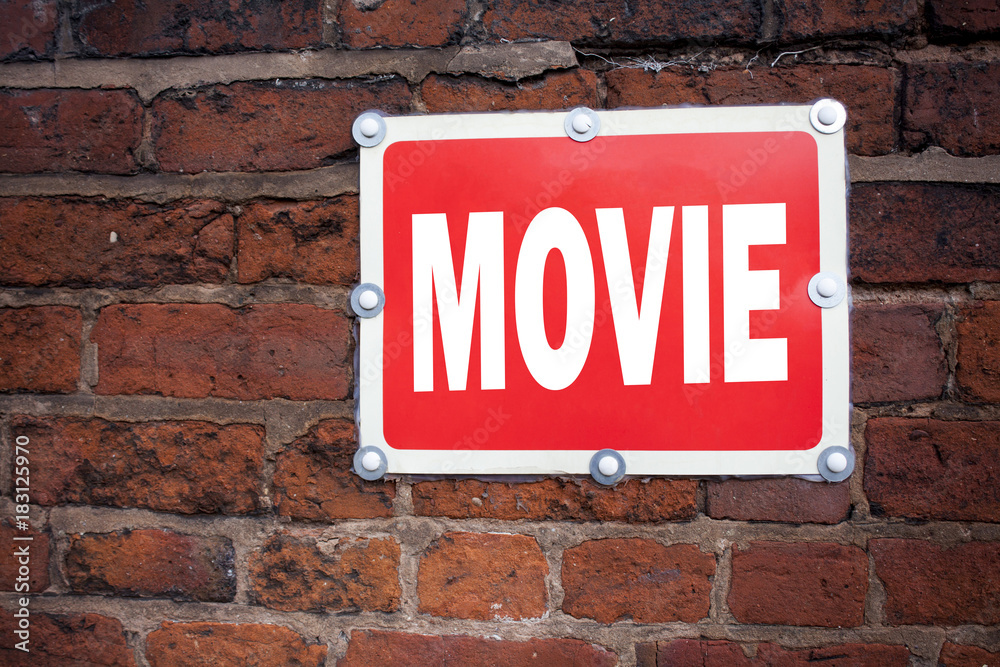 Hand writing text caption inspiration showing Movie concept meaning Entertainment Movie Film written on old announcement road sign with background and copy space