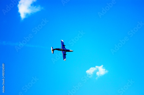 Fototapeta Naklejka Na Ścianę i Meble -  Airplane flying in the blue sky among clouds