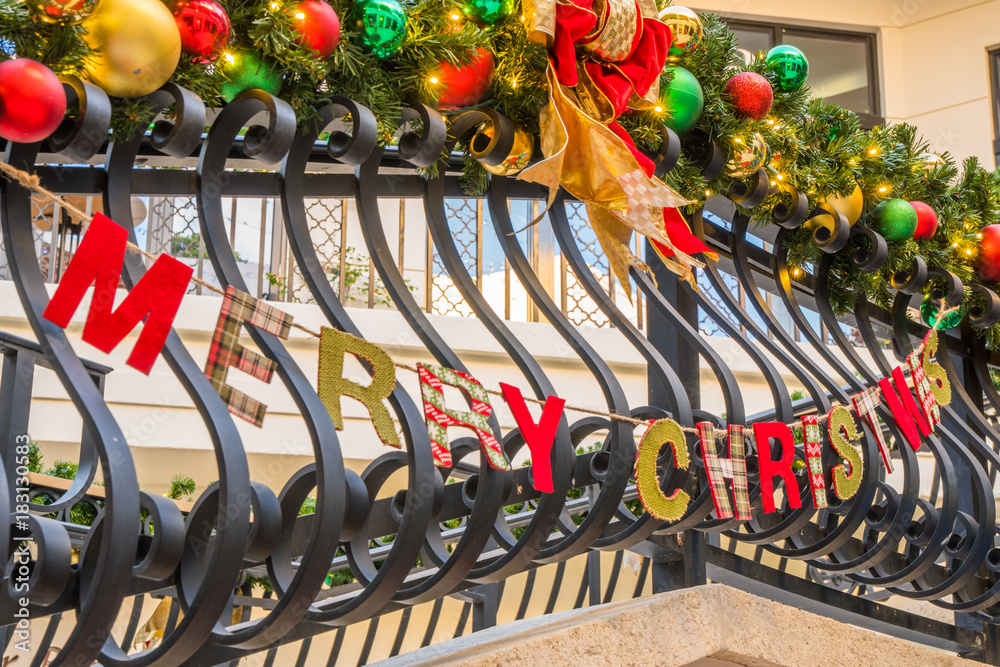 Merry Christmas banner and decorations on railing