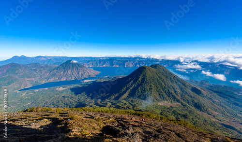 Panorama view of Lake Atitlan and volcano San Pedro and Toliman early in the morning from peak of volcano Atitlan, Guatemala. Hike on Vulcano Atitlan.