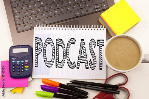 Word writing Podcast in the office with laptop, marker, pen, stationery, coffee. Business concept for Internet Broadcasting Concept Workshop white background with copy space