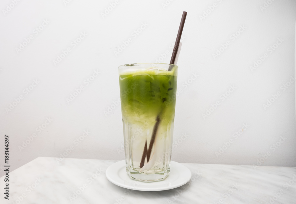 ice green tea drink with coconut in glass on white background. ice green tea drink with coconut in glass on white background.