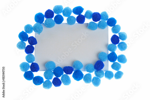 Pompon Mockup. rectangular frame of bright dark blue and blue little woolen pompoms isolated on white background. Winter Mock up. copy space