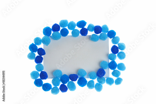 Pompon Mockup. frame of bright dark blue and blue little woolen pompoms isolated on white background. Winter Mock up. copy space