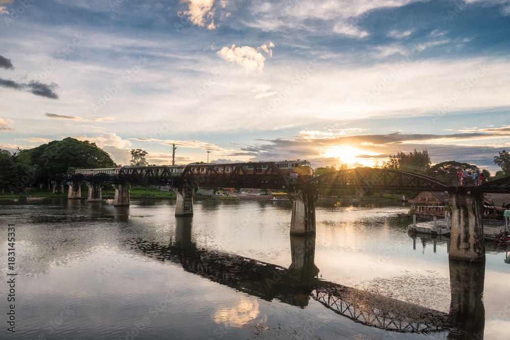 Ancient train running on bridge in River Kwai landmark of Kanchanaburi