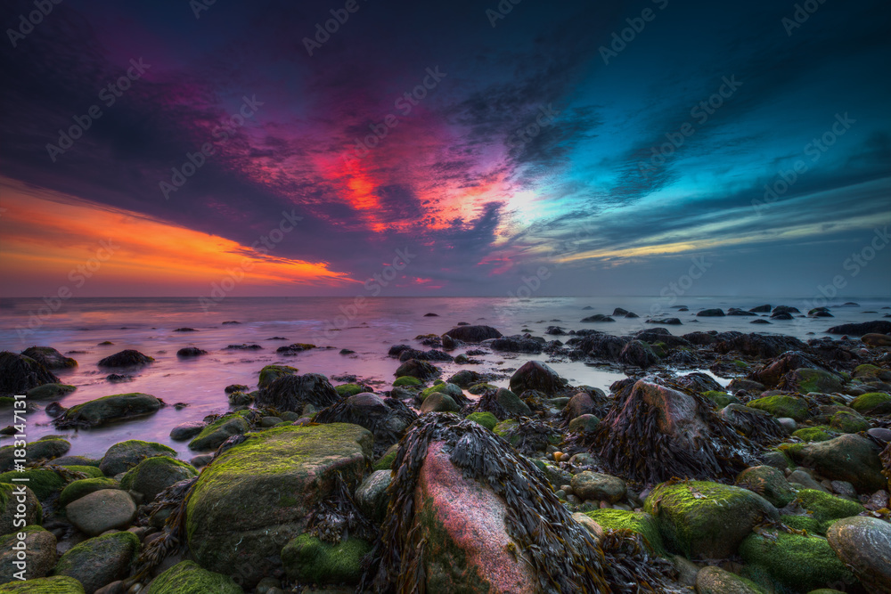 Pre-dawn minutes colorful sunrise explosion of colors. Montauk, Long Island, NY