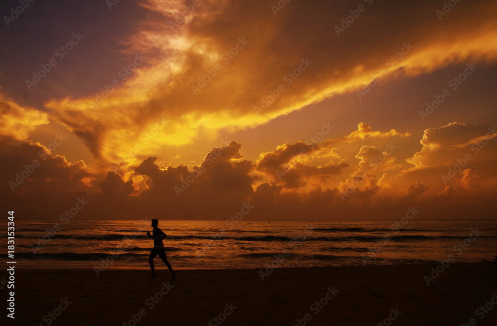 Fit Young man jogging in beach