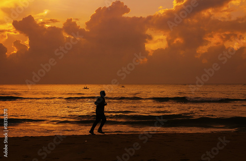 Fit Young man jogging in beach