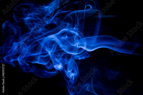 Blue toxic fumes movement on a black background. © peterkai