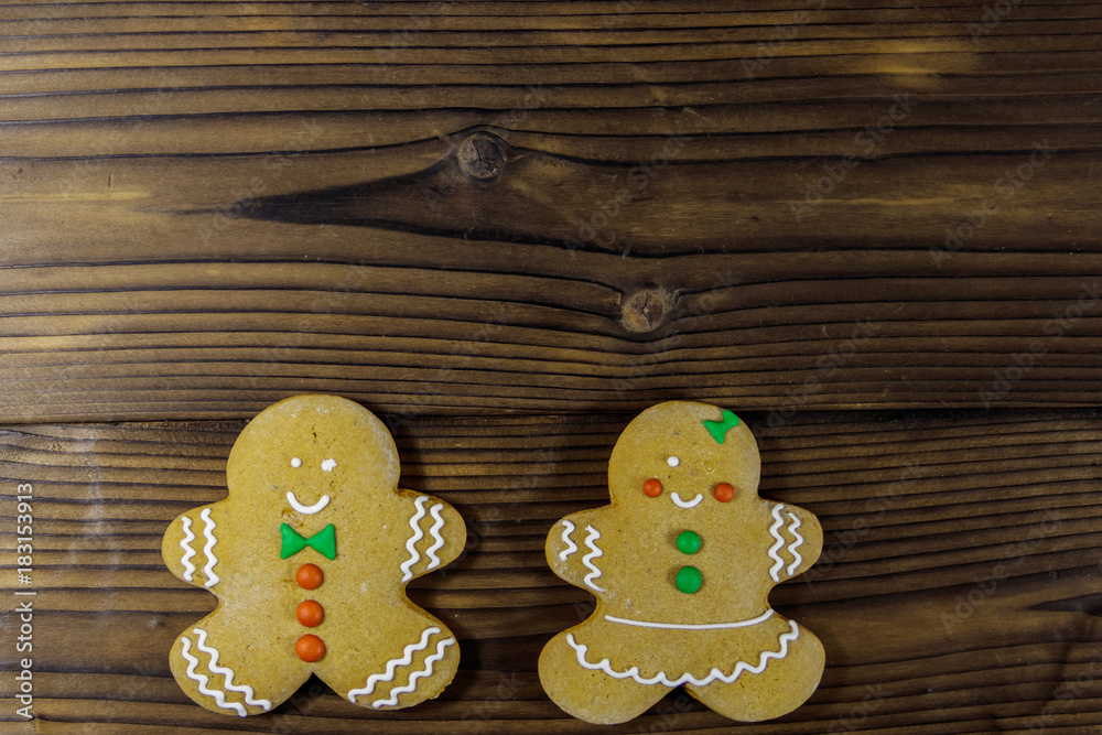 Christmas gingerbread couple cookies on wooden table. Top view Christmas gingerbread couple cookies on wooden table. Top view