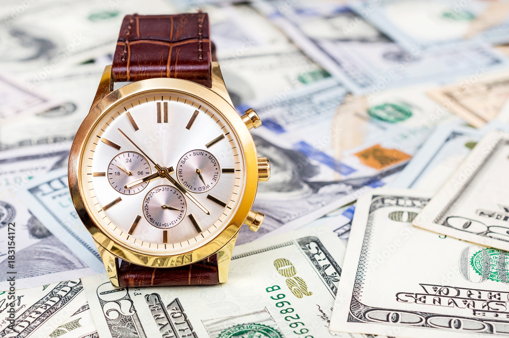 Wrist watch on dollars background. Business concept. Wrist watch on dollars background. Business concept.